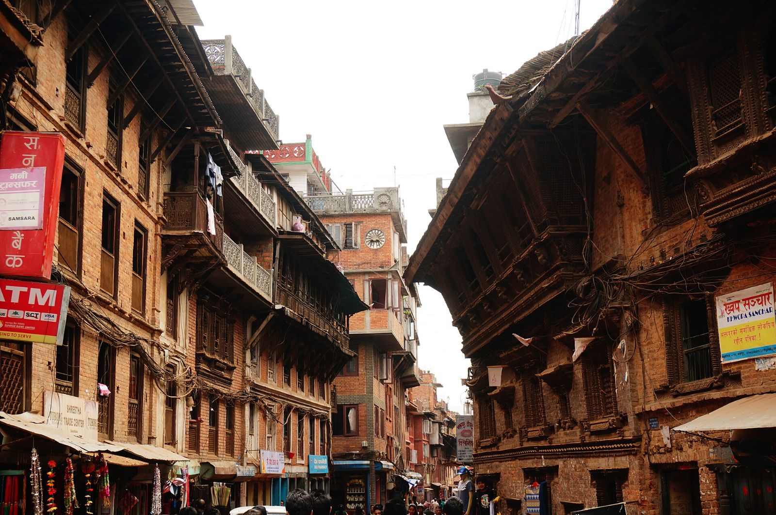Old brick houses with carved wooden windows on a Bhaktapur street