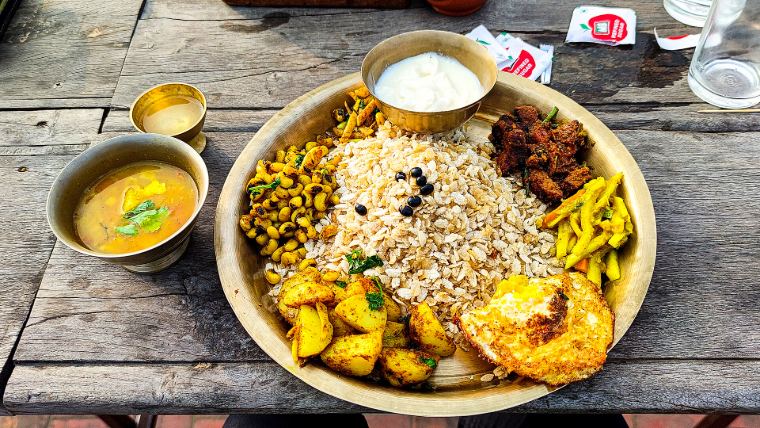 Newari breakfast plate with beaten rice, beans and pickles